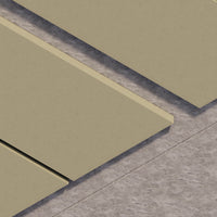 Close-up of green tiles with a gray border on a concrete floor.
